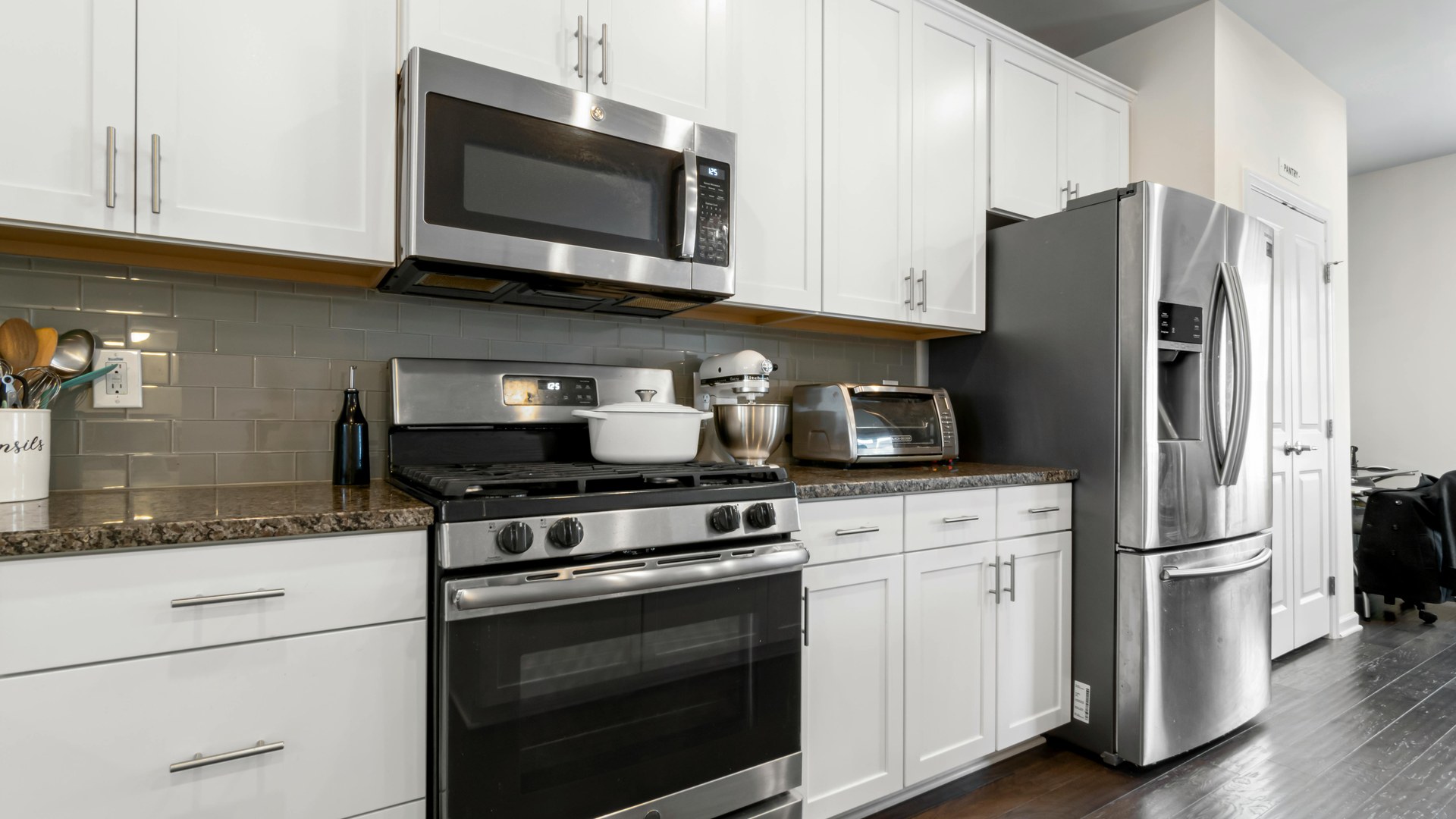 Light oak kitchen with white benchtop and soft neutral finishes