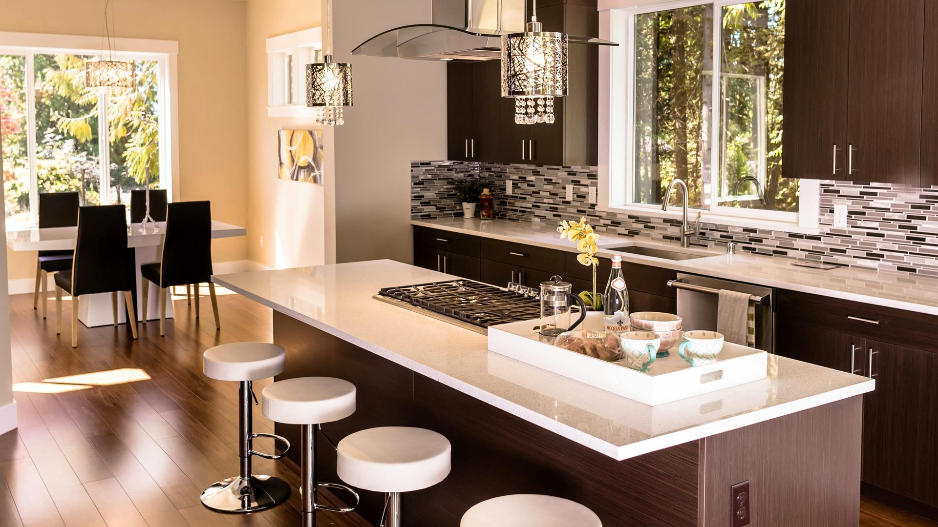 Warm timber kitchen with island seating and black appliances